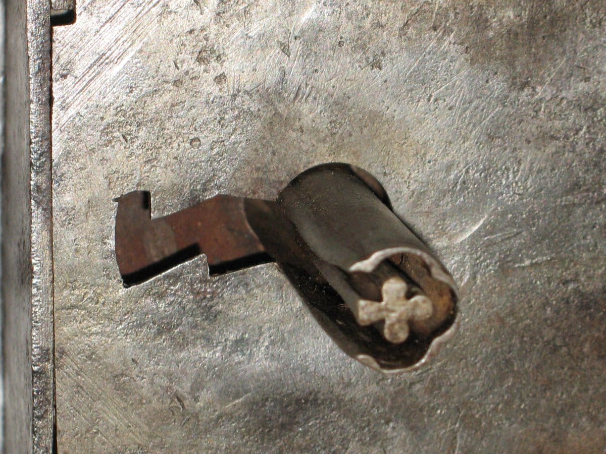 Ancient forged door key and four-leaf clover lock