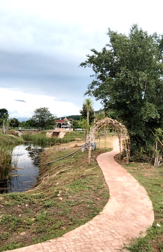 View from Plot 1 over the lake, island, and mountain landscape at Natural Healthy Village